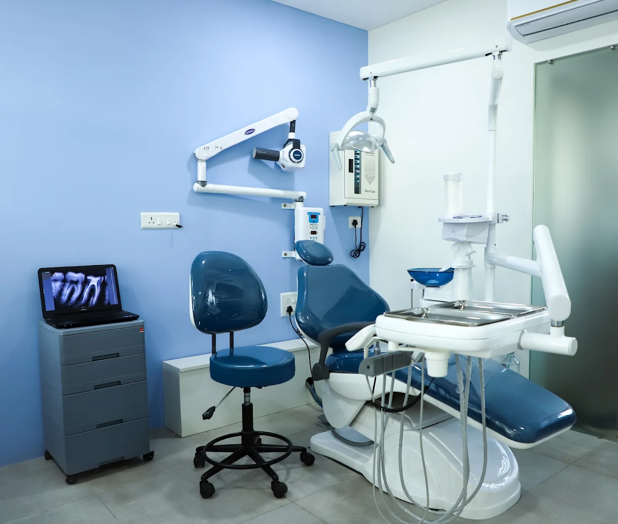 Modern dental chair with wall-mounted X-ray unit and digital radiograph screen at GRIN Dental Care